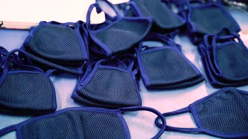 Pices of face masks in the workshop Factory for production. Manufacture of potective masks