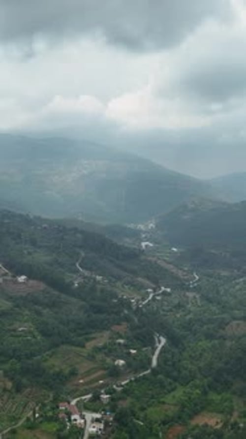 Vertical Video Aerial Rainfall Retreat Views of a Cozy Mountain Village