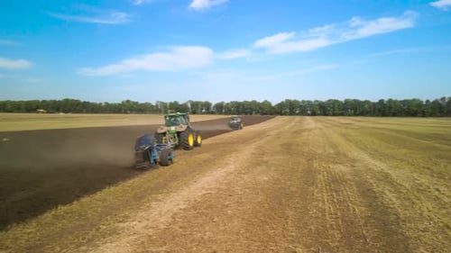 Tractors plowing the field in Ukraine