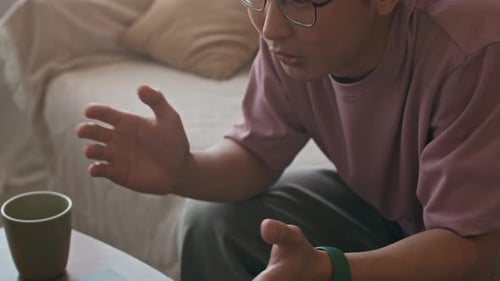 Young Man Explaining Something During a Virtual Meeting