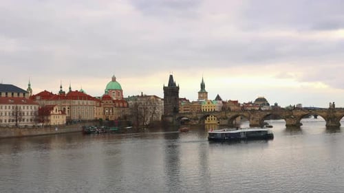 Charles Bridge and Vltava River with Tourist Boat in Prague