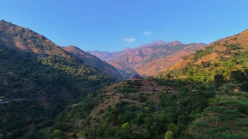 chkarata shot of mountain landscape with rugged terrains and rolling hills basking in sunlight,