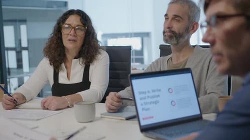 Mature Business Team Sharing Ideas on Office Meeting