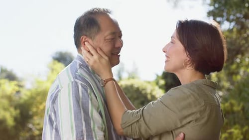 Happy Couple Embracing Affectionately Outside in Sunlight