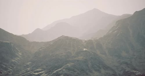 Dramatic Mountain Range Under Soft Light During Early Morning Hours