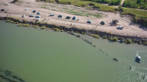 migrants crossing the Rio Grande into Eagle Pass, Texas. interaction between migrants and the Border