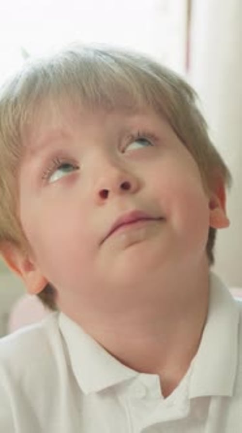 Child Draws and Looks Upward