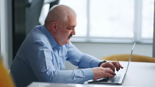 Aged Man Working With Laptop In Home Or CoWorking Office Portrait Person Typing Messages