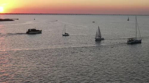 Aerial View Of Boats Sailing At Calm Waters Of Lake Pontchartrain During Sunset.