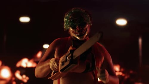 Creepy Clown Holding Chainsaw in the Dark