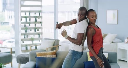 Happy Couple Dancing Back-to-Back at Home