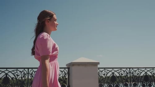 Woman Gazes Thoughtfully Sunlit Promenade Features Contemplative Woman in Pink Scenes Depict