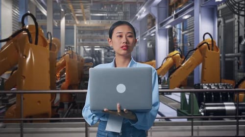 Woman Holding Laptop in Modern Automated Factory
