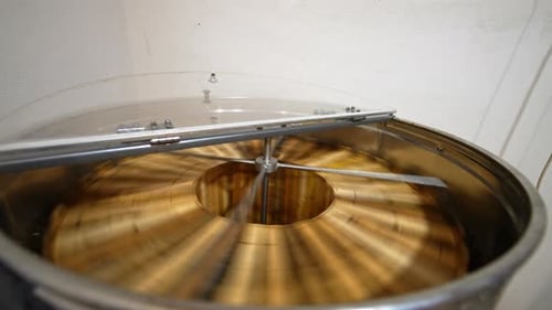 Rotating Metal Honey Extractor Machine in Workplace