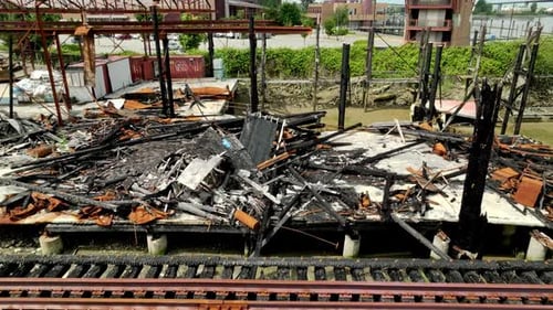A Burnt Building Lies in Ruins Beside the Rail Bridge Along River Drive in Richmond, British