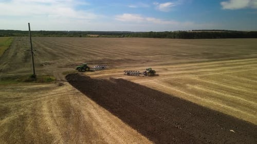 Tractors plowing the field in Ukraine