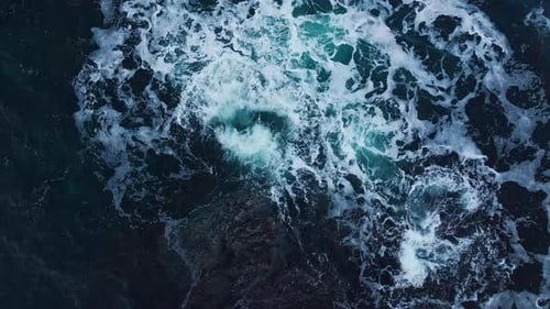 Waters of the Ocean Swirl Around the Rocky and Scenic Coastline Sea Waves Breaking Over Rocks