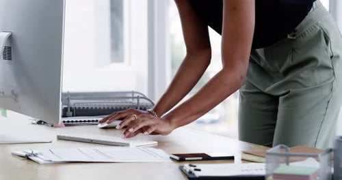 4k video footage of an unrecognizable young woman working on a computer in a modern office
