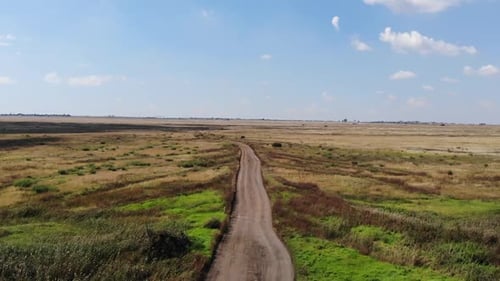 Gravel road with water drainage cut aways for the heavy rainy season ahead