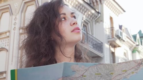Woman Using a Map in Urban Setting