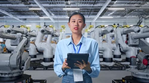 Engineer Using Tablet in Robotics Manufacturing Factory