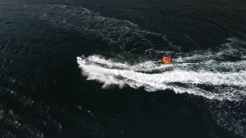 Jet Ski Tows Raft Aerial View in Ocean
