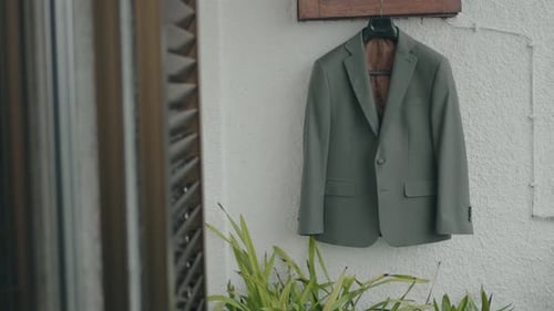 Elegant Suit Jacket Hanging on Textured White Wall