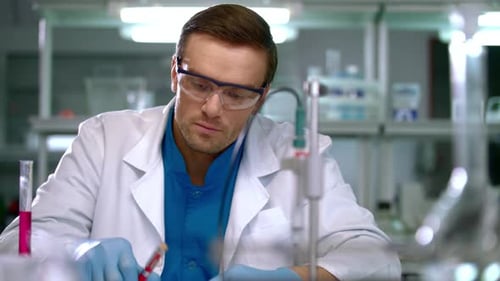 Scientist Researching and Taking Notes in Laboratory Setting