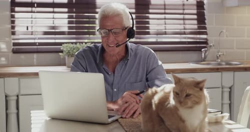 Older Man Working at Home with Cat