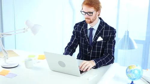 Redhead Businessman Working On Laptop in Office Creative Freelancer Designer