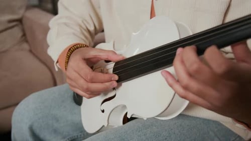 Close-up of Unrecognisable Teenage Girl Playing Violin during Music Rehearsal
