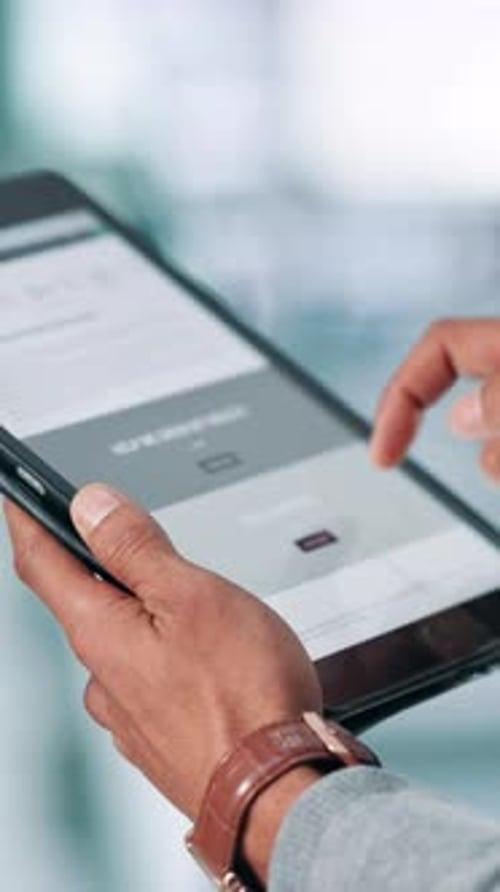 Man Interacting with Tablet in Airy Workplace
