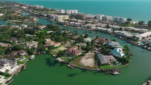 Drone Above Footage Boat Sails on the Bay There are Many Private Houses on the Shore of the Bay