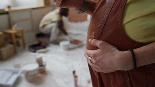 Anonymous Expectant Mother Stroking Tummy While Texting Messages