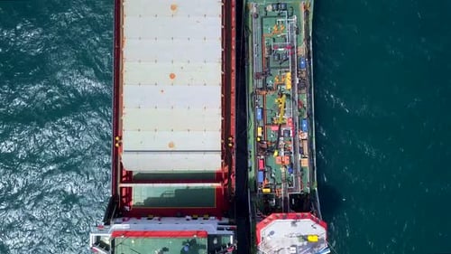 Aerial footage of a Small Oil products ship fuelling a large Bulk carrier.