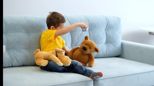 Child Plays with Stuffed Animals on Couch