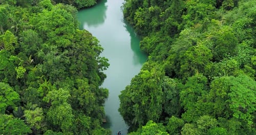 Aerial Top View of Clear River Flowing Over Rocks in Tropical Canyon