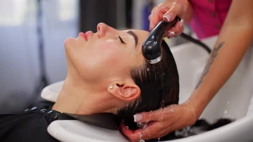 Woman Getting Hair Washed at Hair Salon