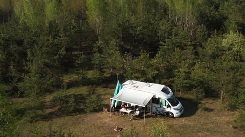 An Aerial View of a Family Holiday Near a Motorhome in the Woods Travel Concept