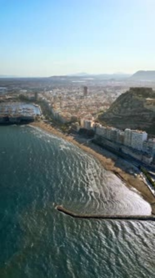 Aerial drone view of the Santa Barbara Castle on the coast of Alicante, Spain with the city and the