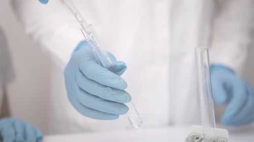Clear Liquid Added to Test Tube in Lab