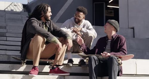 Friends Relaxing on Steps With Skateboards