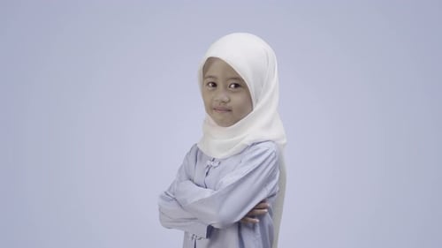 Smiling Girl with Arms Crossed Wearing a Hijab