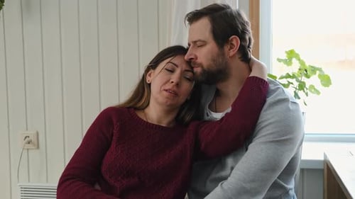 Loving Couple Embracing Comfortably Indoors
