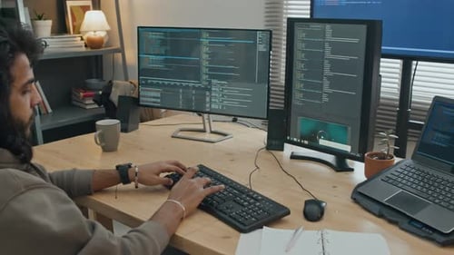 Software Developer Writing Computer Code at Home