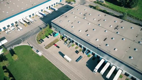 Logistics park with warehouse. Semi-trailers trucks standing on car parking and waiting for loading