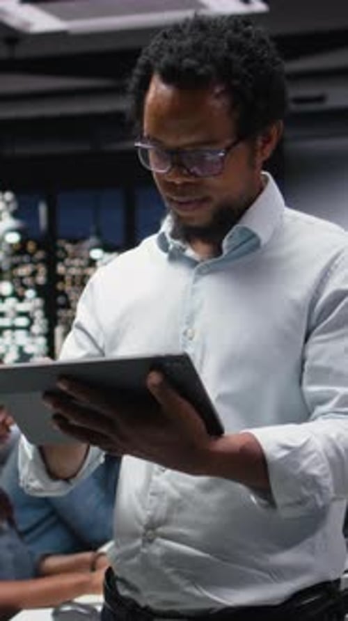 Vertical Video IT Expert Using Tablet in Office Working with AI