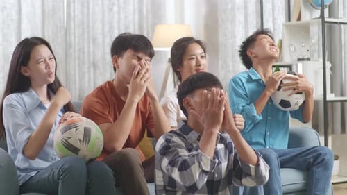 Friends Watching a Soccer Game Together Indoors