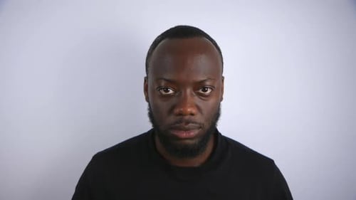 Black Male Looking Up In An Angry State With White Background