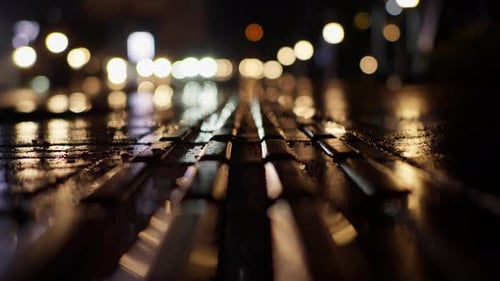 Blurred View Of Cars Traffic and Lights Along Wet Urban Street Road At Night